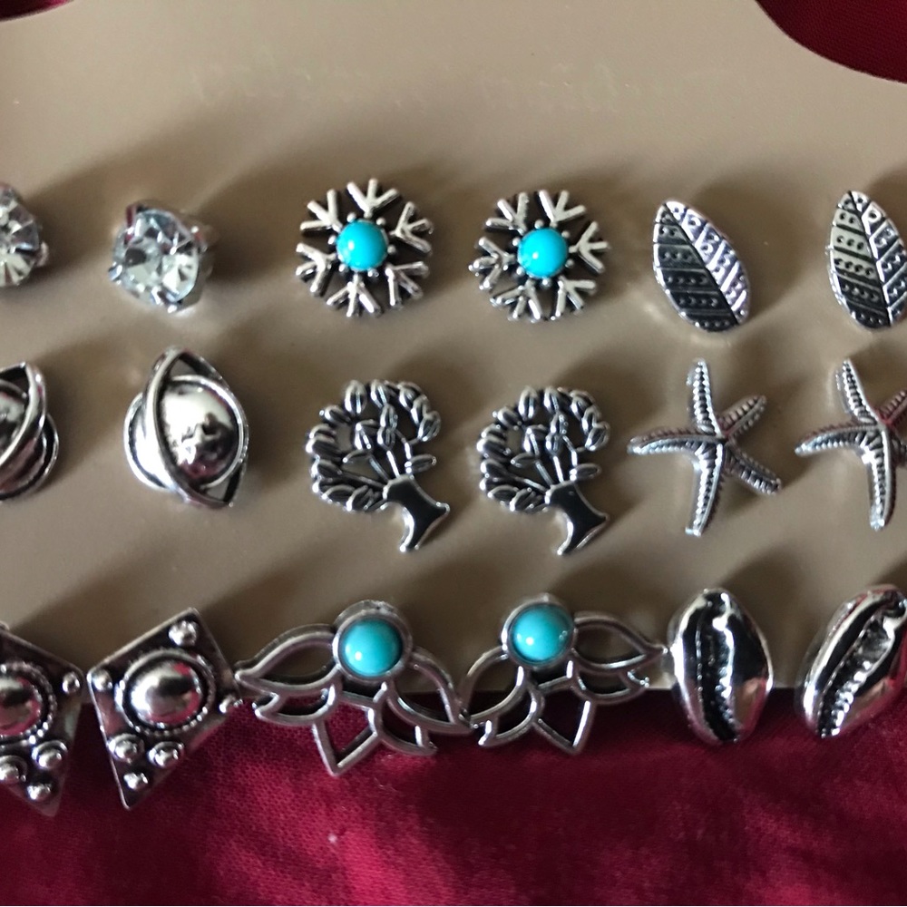 9 pair card of silver tone earrings.